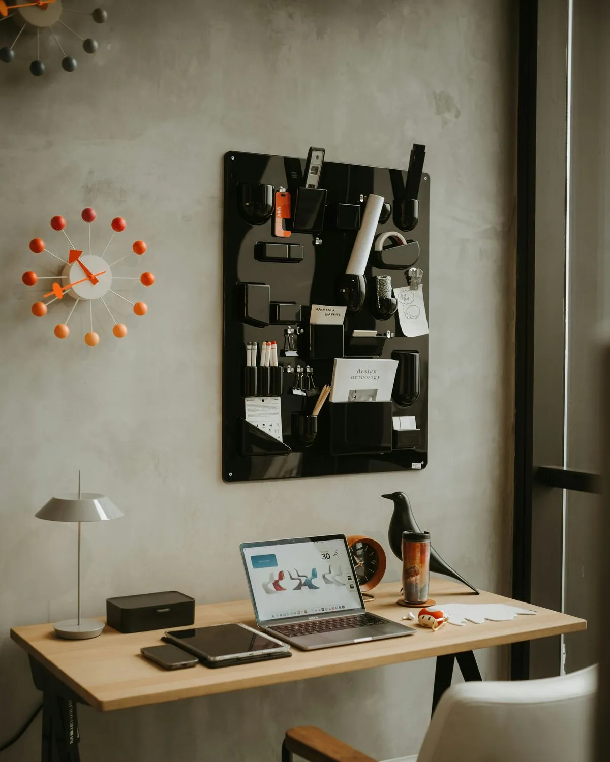A tidy desk with a laptop in a bright workspace
