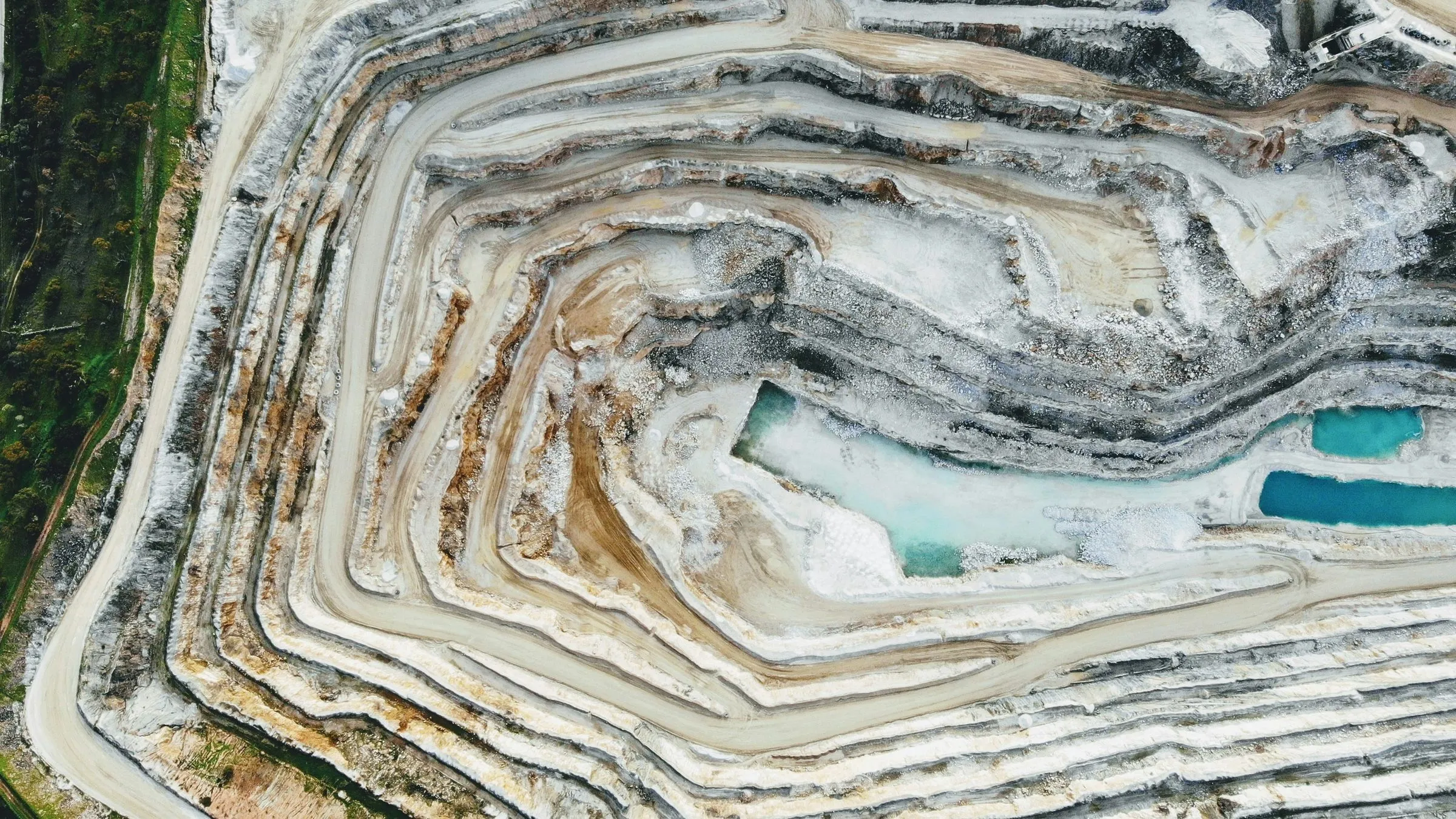 An open-pit mine seen from above, cut into terraces