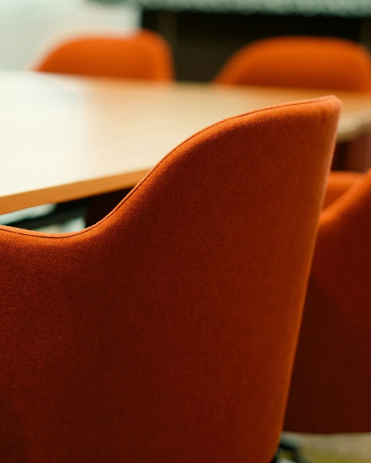 Orange chairs around a meeting table