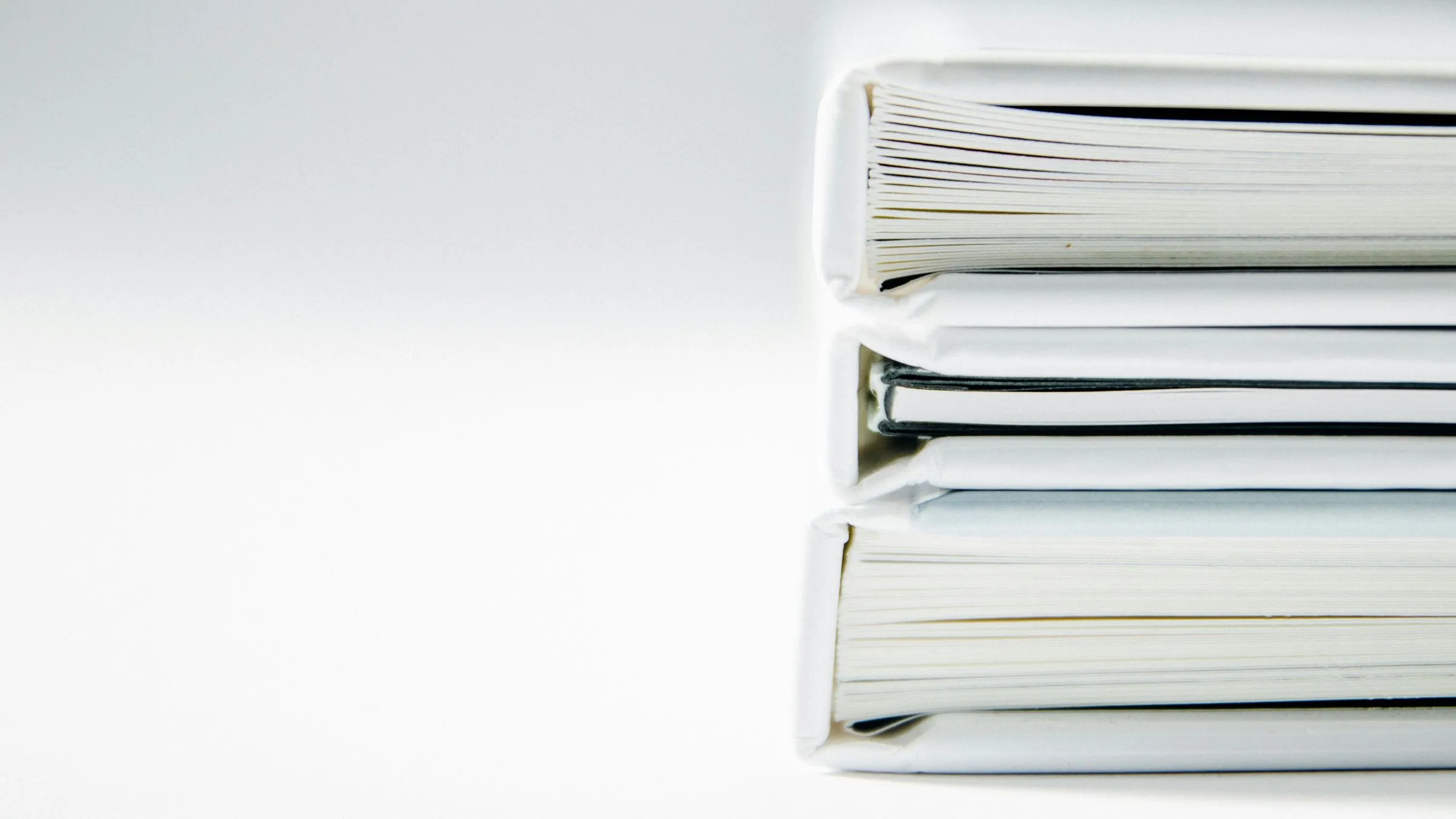 A neat stack of white folders