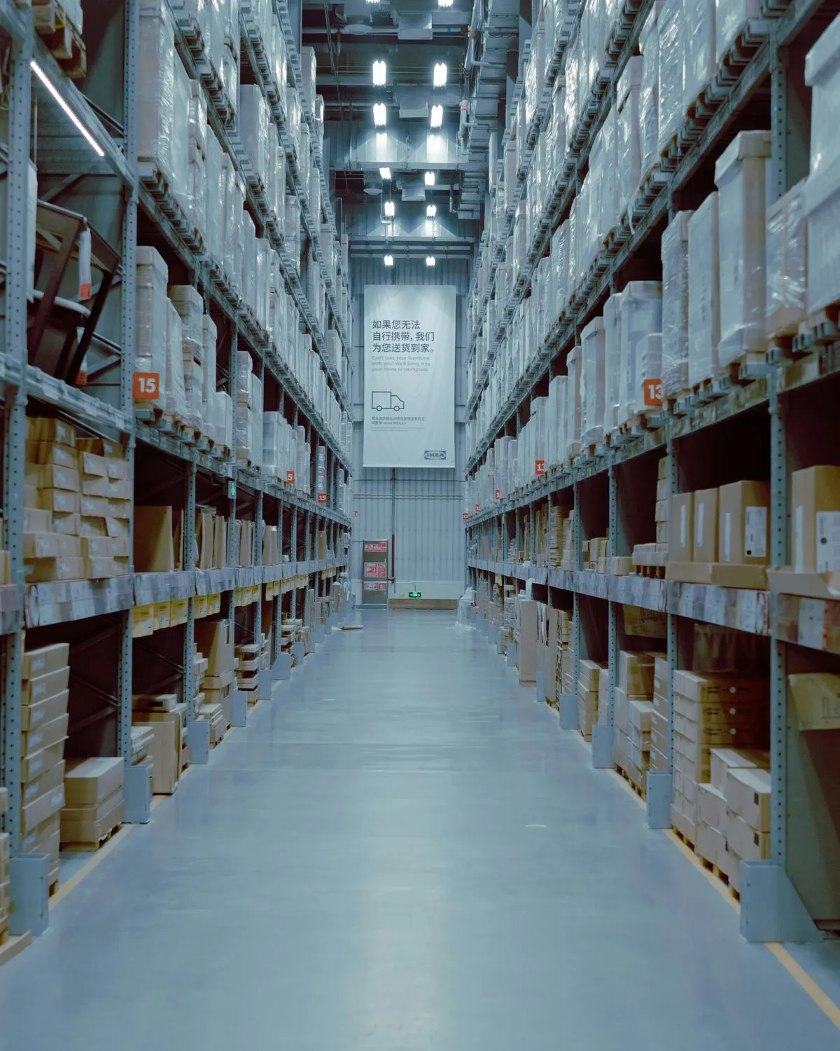 A long warehouse aisle lined with shelving