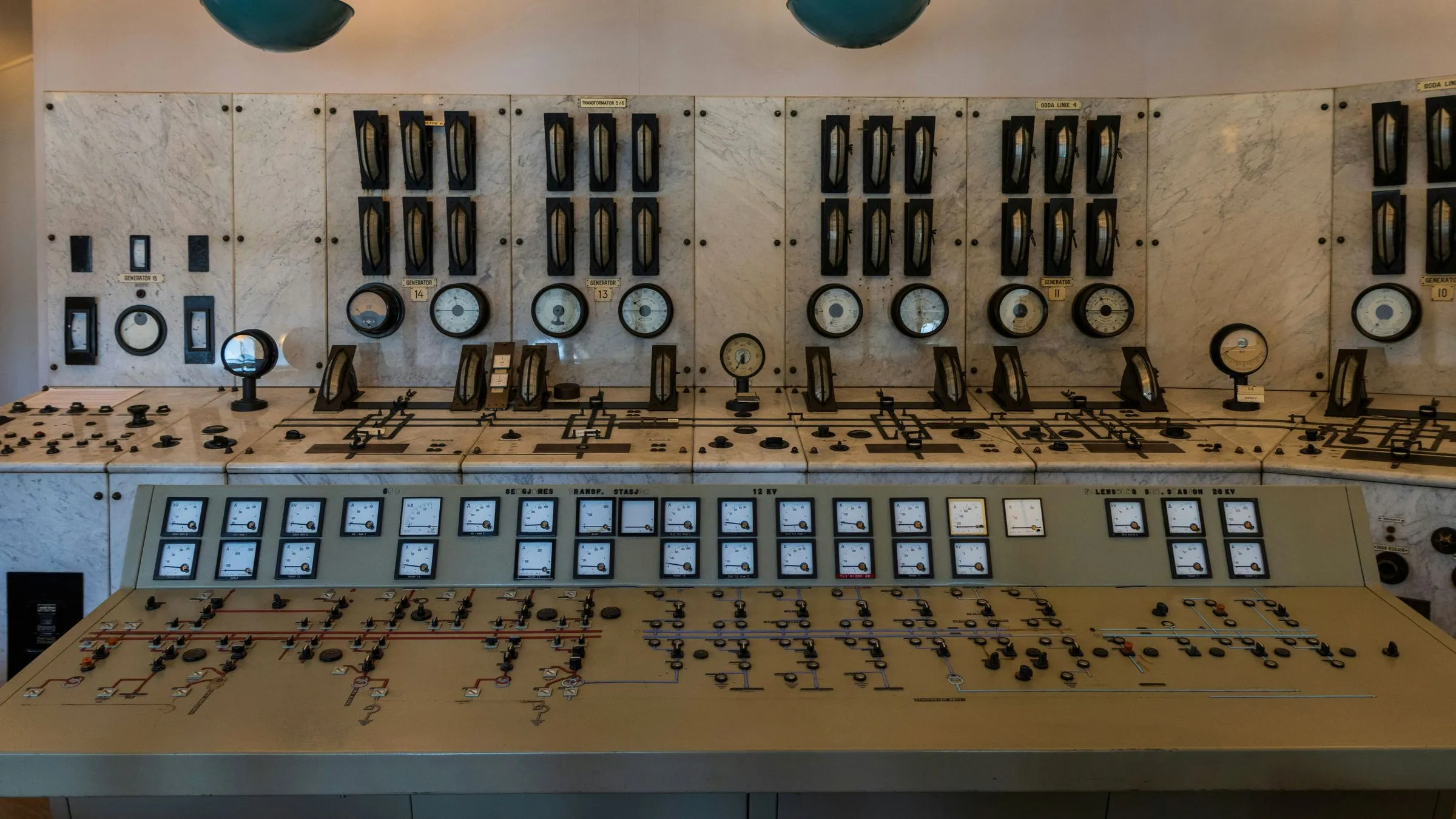 A control room with banks of dials and switches